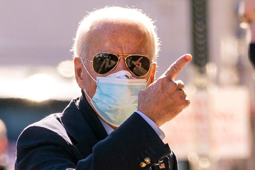 President-elect Joe Biden gestures as he arrives at The Queen theater.