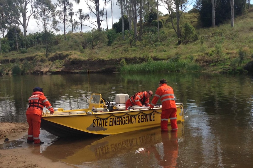 SES crews load a boat into water near Twin Bridges Reserve