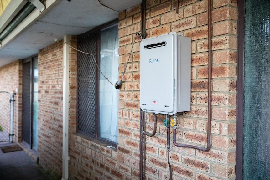 A new gas hot water system plugged into a double adaptor outside.