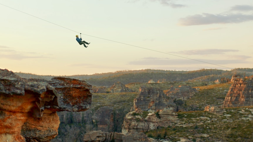 An artist's impression of a man on a zipwire crossing a canyon.