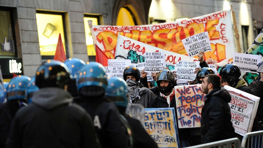 Anti-austerity protesters clash with police outside the Scala opera house in Milan before the premiere of Fidelio.