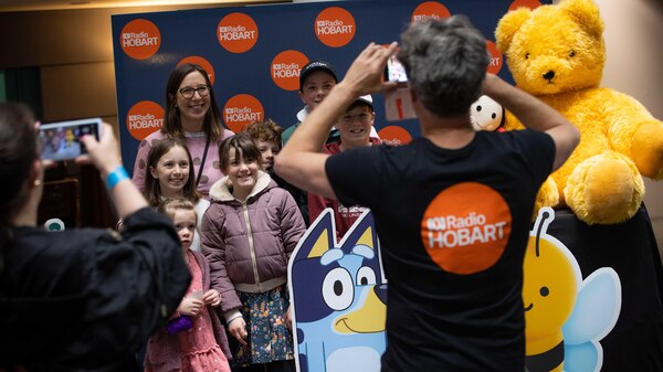 Ryk Goddard takes photo of family posing with ABC Kids characters