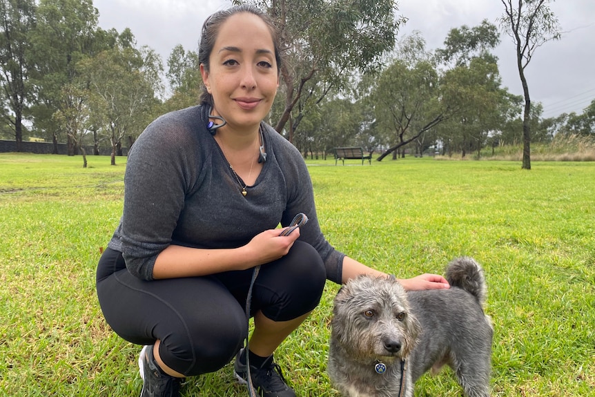 A woman with a small dog.