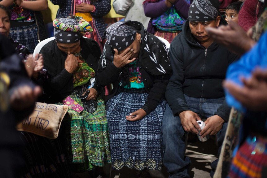 Lidia Gonzalez and other relatives cry during the wake for her daughter