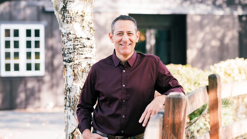 Populus group CEO Bobby Hererra standing in front of a house smiling.