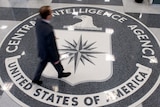 Man walks over logo at CIA headquarters