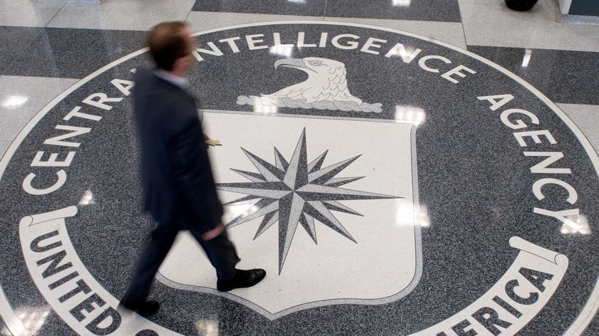 Man walks over logo at CIA headquarters