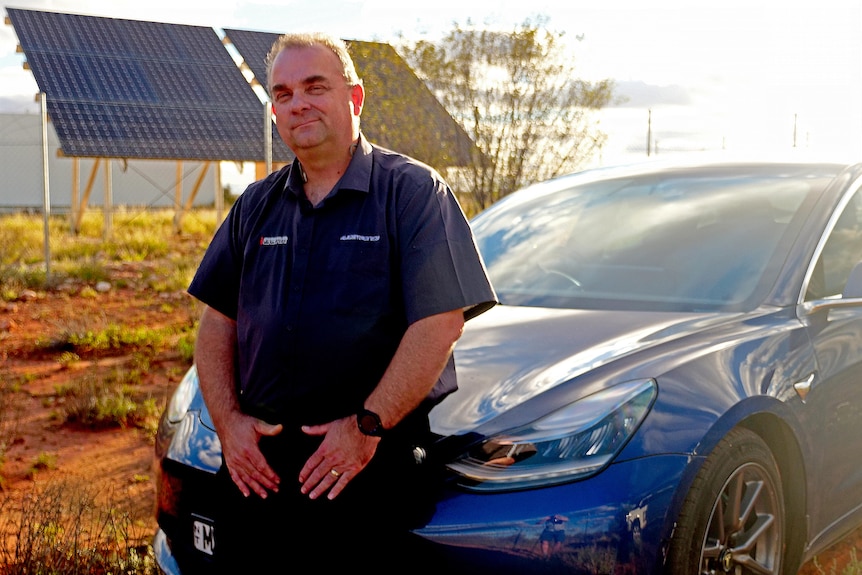 A man sits on an electric vehicle.