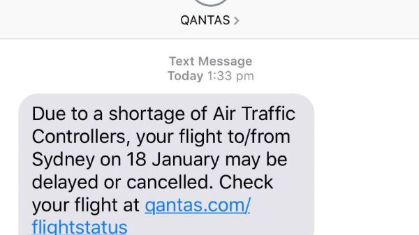 A text message from Qantas to customers informing them of delays due to a shortage of air traffic controllers.
