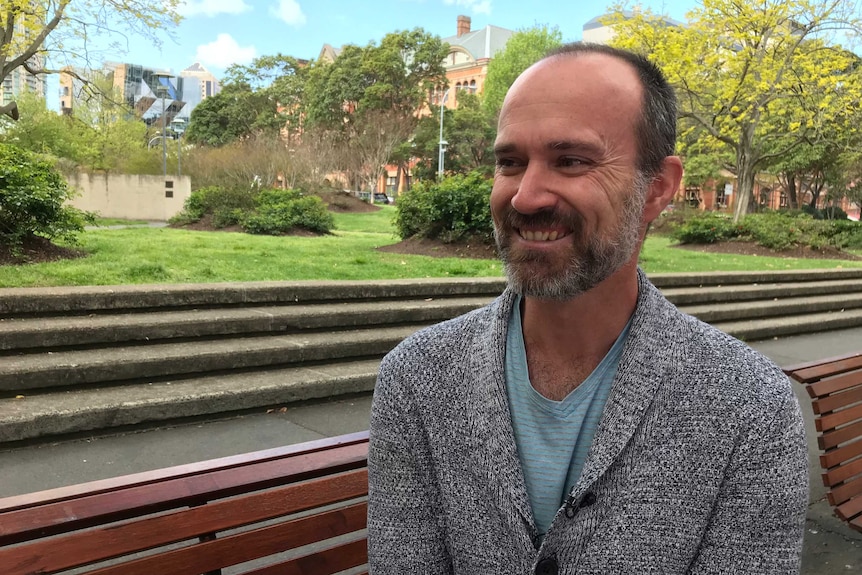 Off-the-plan property buyer Stephen Kendon sits on a park bench.