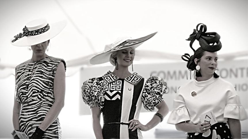Three ladies wearing black and white race fashion