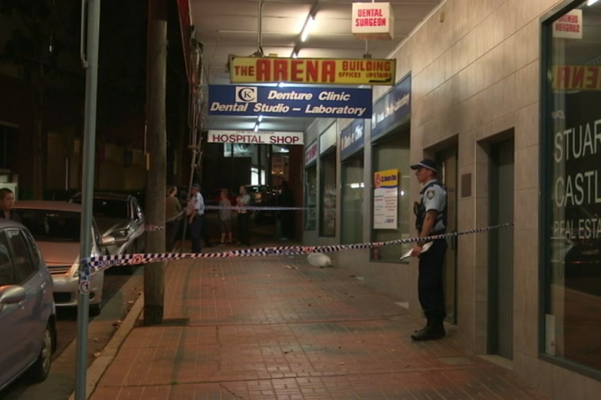 A police officer standing outside a shopfront