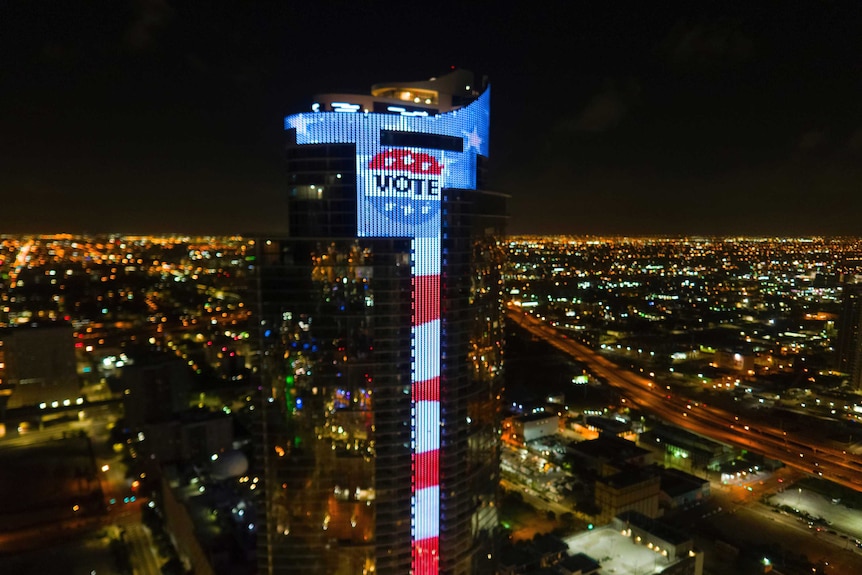 A display on a Miami skyscraper reads VOTE.