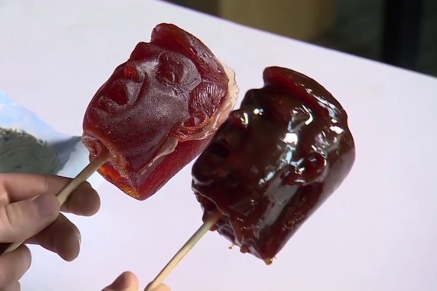 Two lollipops in the shape of Donald Trump's head, created by Russian artist Alexei Spirenkov.
