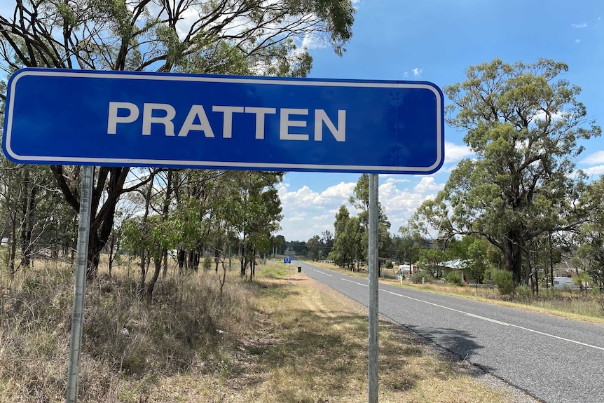 A blue street sign that says Pratten next to a quiet sealed country road.