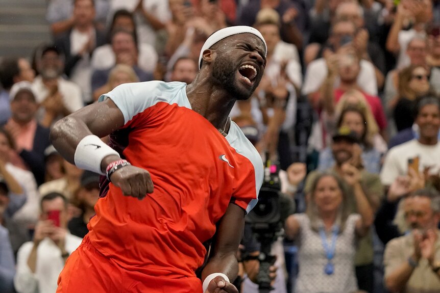 Frances Tiafoe shouts with joy after winning a match at the US Open.