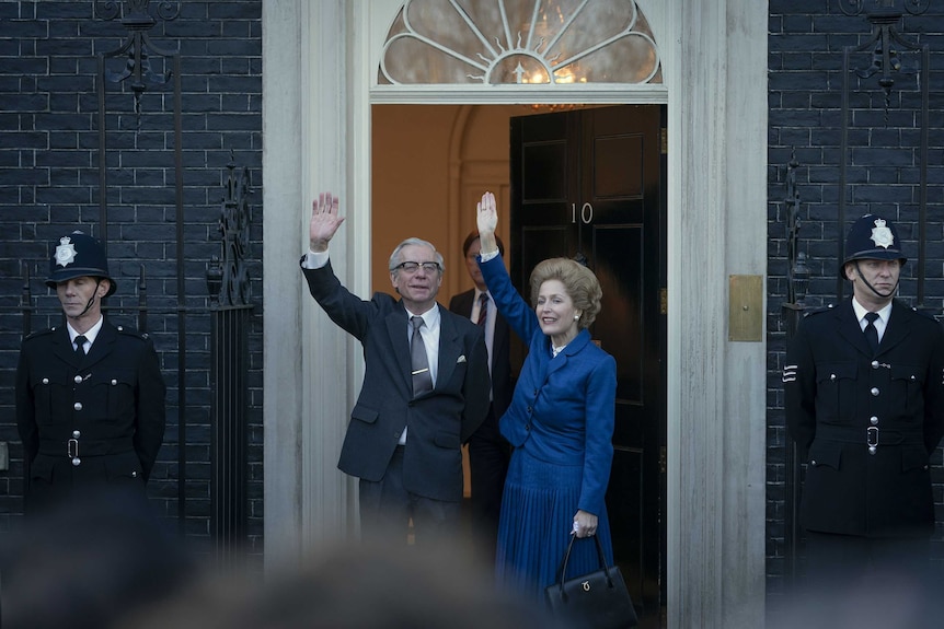 Gillian Anderson dressed in blue with her hair like Thatcher, stands at the door of Number 10 Downing St