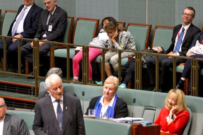 MP Phillip Ruddock delivers his long valedictory speech as three of his grandchildren wait for it to end.