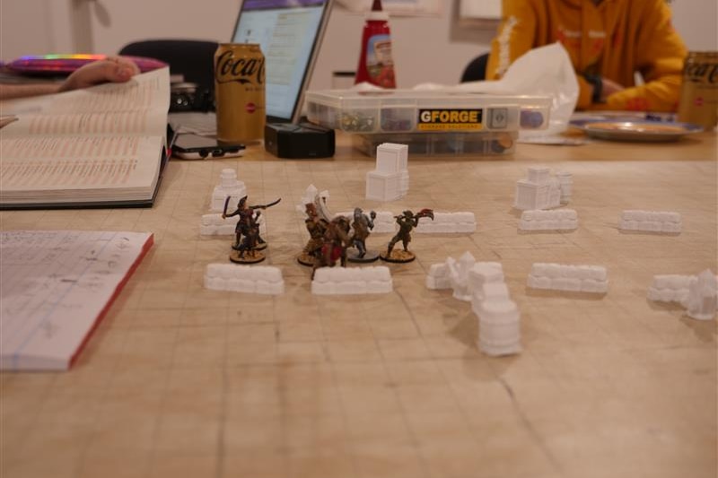 A picture of mini figs on a Dungeons and Dragons table. 