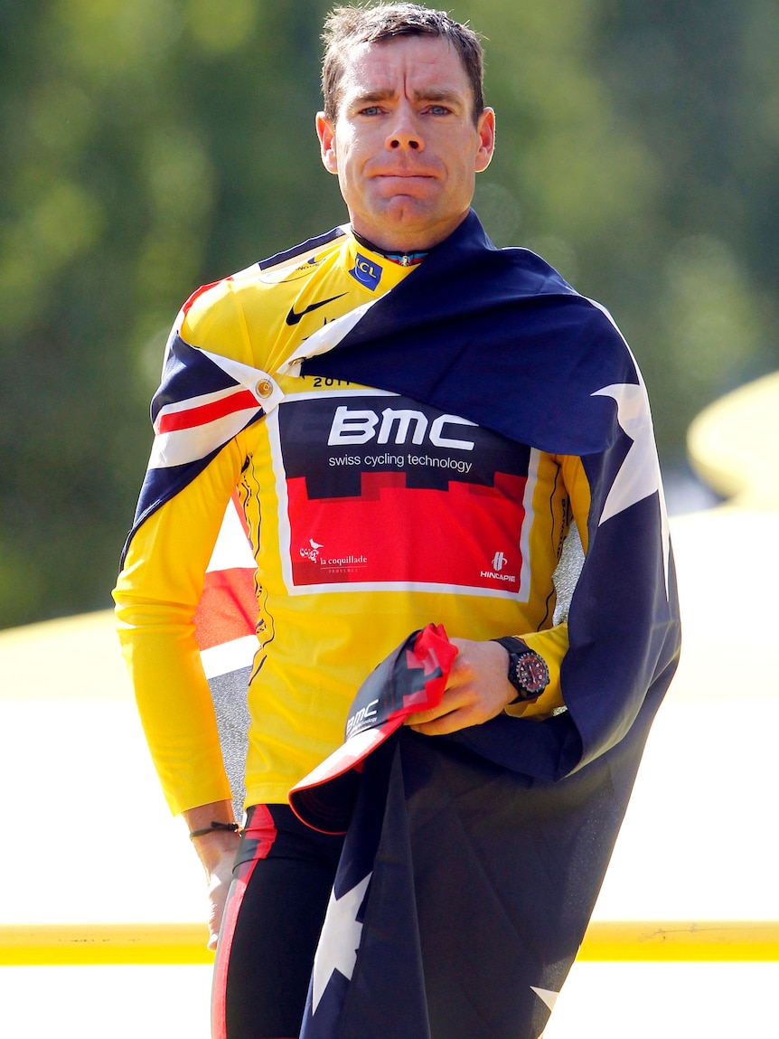 Cadel Evans, draped in an Australian flag, celebrates his Tour de France win.