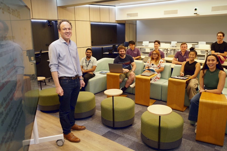 Edward Obbard, head of nuclear engineering at UNSW, with his students in a small classroom.