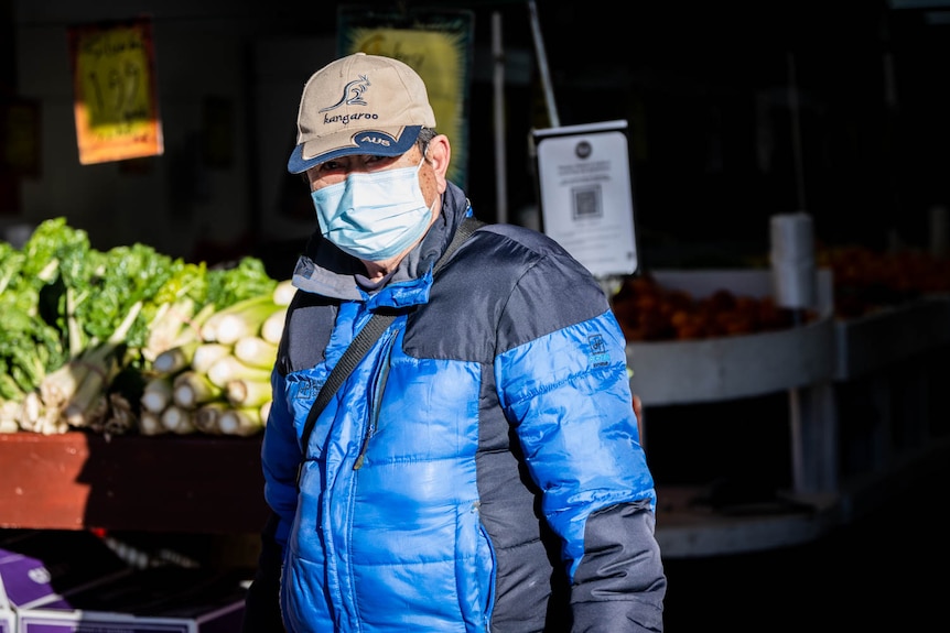 A middle-aged man of Asian background wearing a face mask