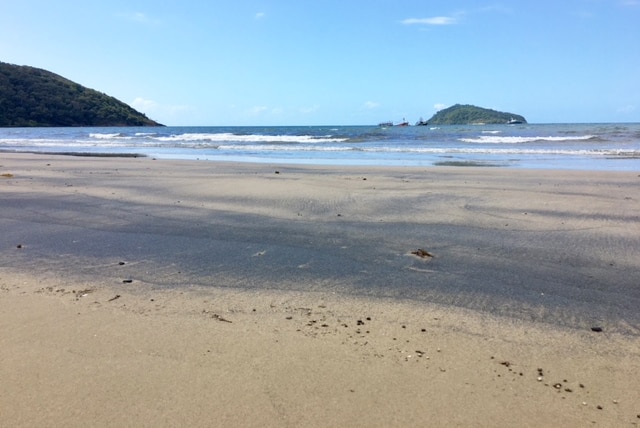 Oil spill in sand on beach from a suspected illegal Vietnamese fishing boat.