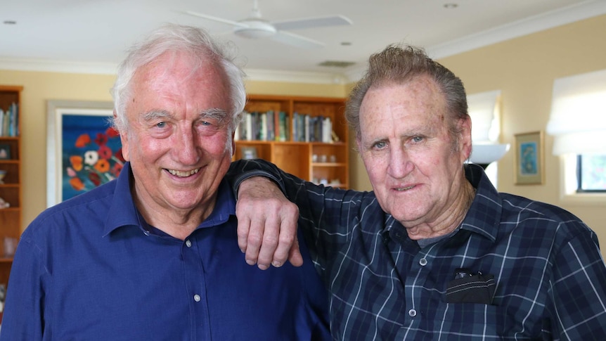 Roger Rees and Warren Porter standing next to each other posing for a photograph