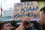 A close up a protest sign reading "Justice for Kian #stopthekilling".