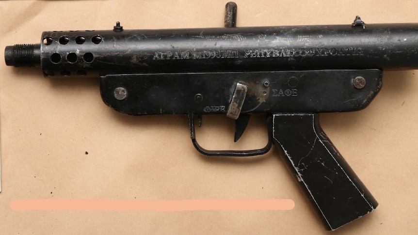 A machine pistol lying on a bench