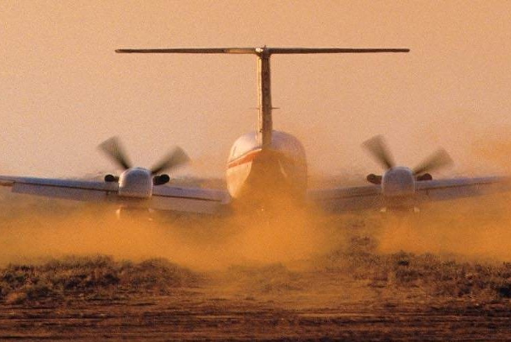 Aircraft on runway with dust flying