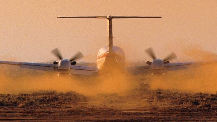 Aircraft on runway with dust flying