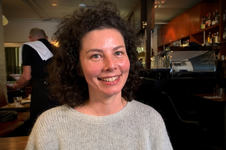 A smiling woman with dark hair.