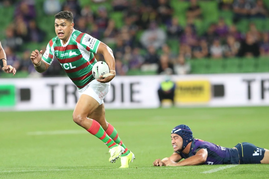 South Sydney Rabbitohs' Latrell Mitchell breaks away from Melbourne Storm's Jahrome Hughes in their NRL clash.