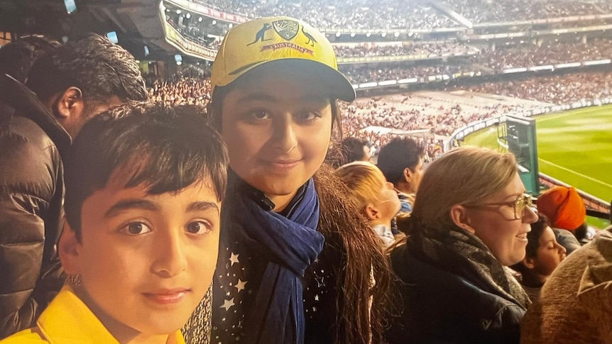 Picture of a boy and a girl in a cricket stadium 