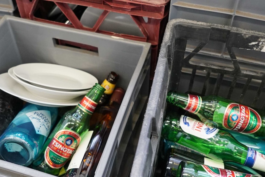 Used bottles lie in crates, ready to be used in the smash room