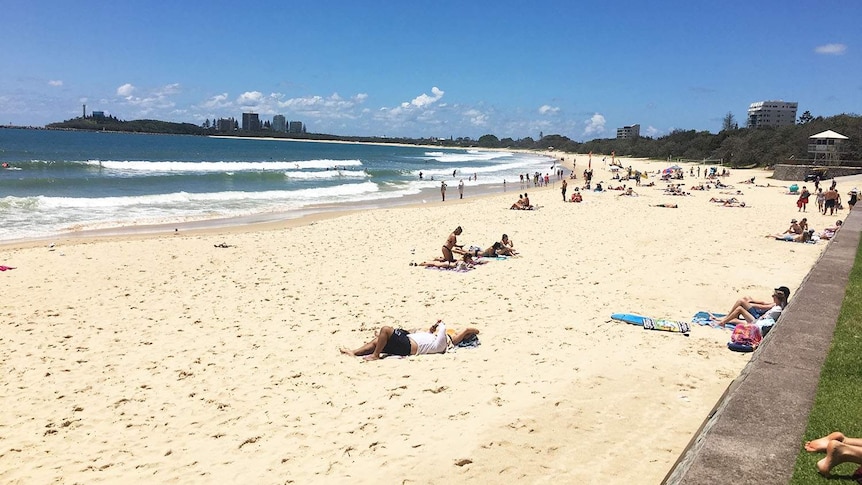 People relax in the sun on Mooloolaba beach on Queensland's Sunshine Coast on November 23, 2017