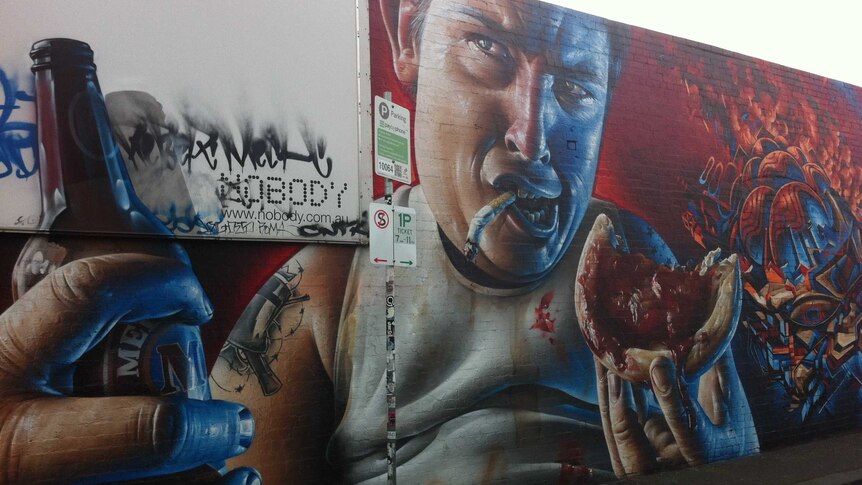 A mural depicting a man drinking beer, smoking cigarettes and eating a meat pie.