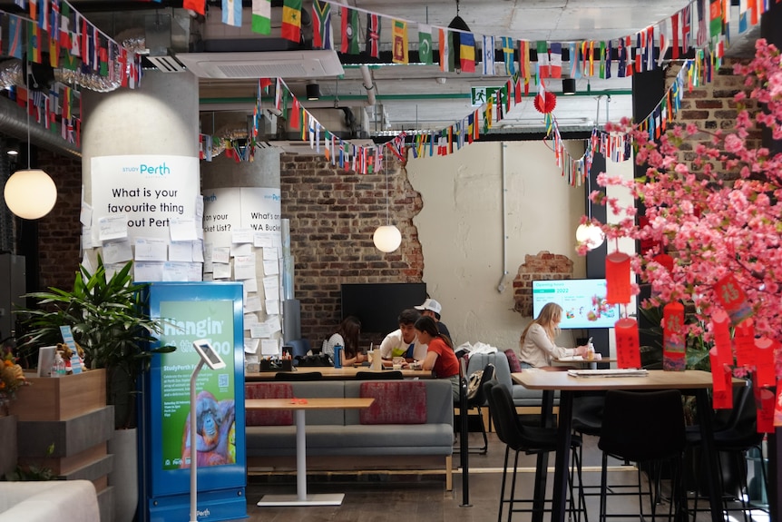 People studying in a bright area adorned with flag bunting