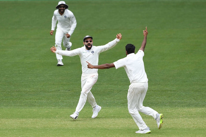 Virat Kohli celebrates India taking the final Australian wicket.