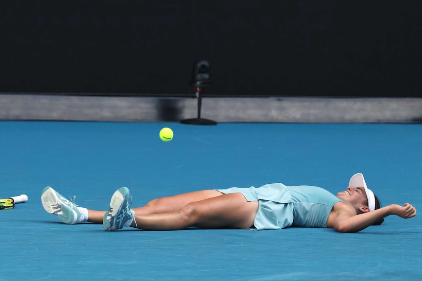 Jennifer Brady lies on the court after winning her Australian Open semi-final.