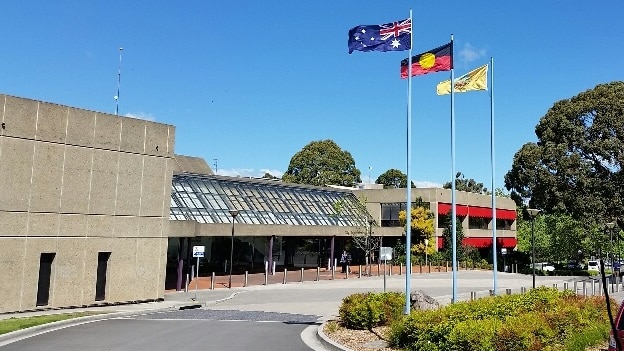 Shoalhaven Council building on a sunny day with flags flying.