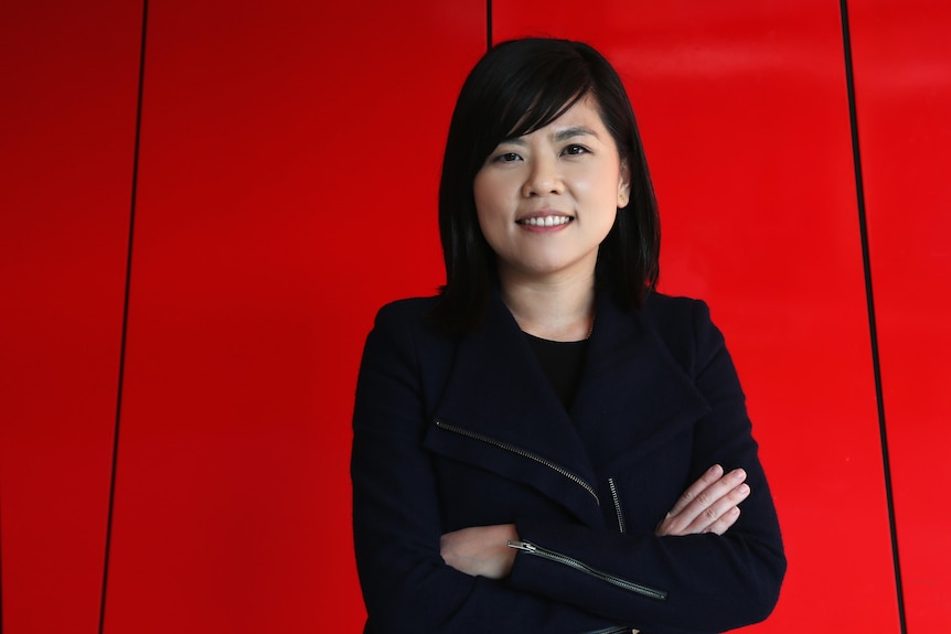 Chinese-Indonesian woman wearing black attire smiling to camera.