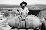 a serviceman sits on a stack of bombs