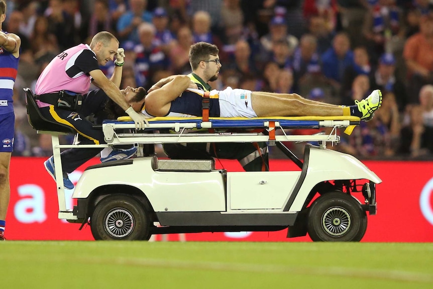 Mitch Brown is stretchered off the ground against the Bulldogs