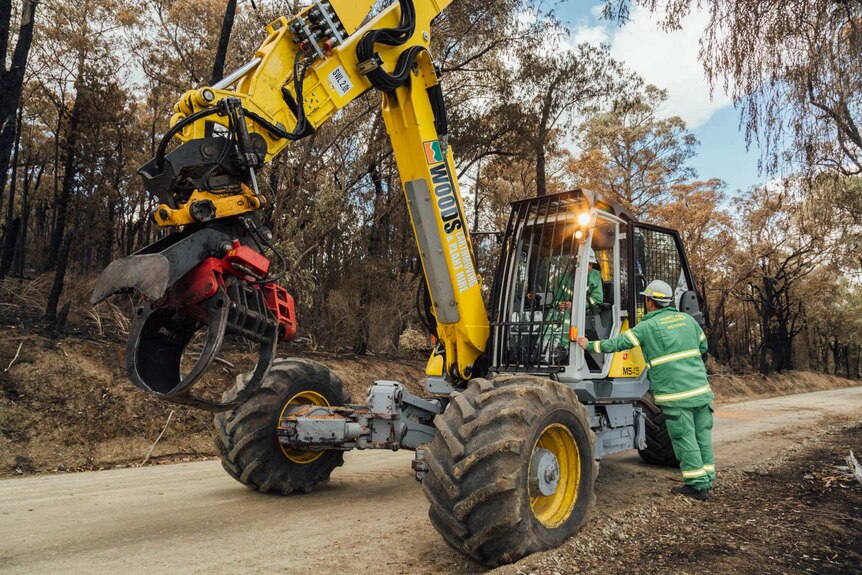 Andy Beckett talk to the driver of a piece of machinery called the Spider in the fire zone area.