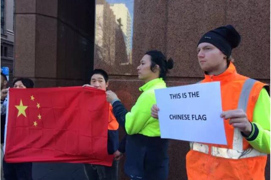 A CFMEU member at a protest demanding an apology for Olympic coverage mistakes