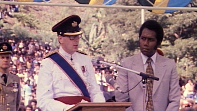 Prince Richard, Duke of Gloucester speaks to the audience while Prime Minister Peter Kenilorea stands by.
