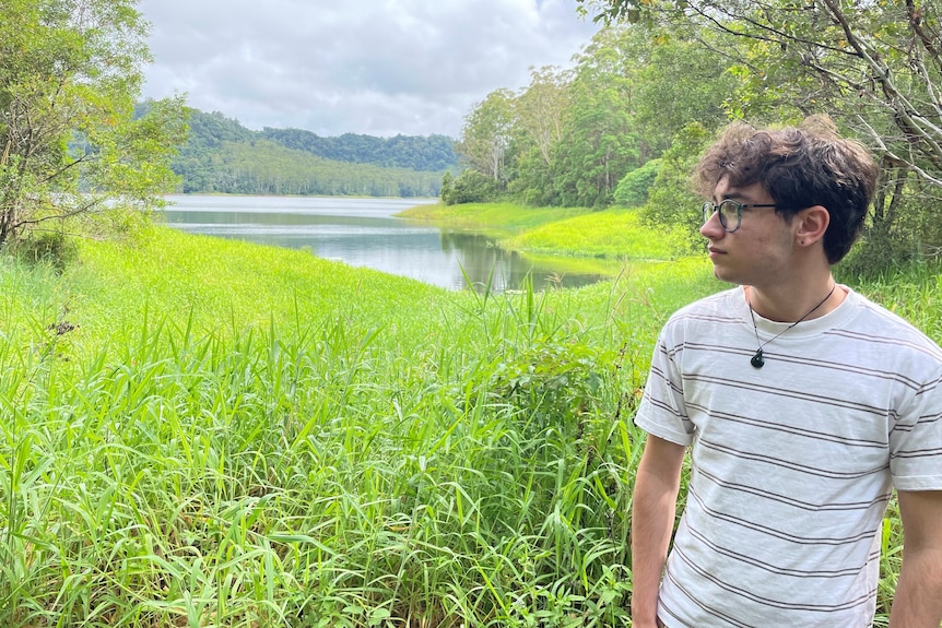 Hugo standing near a body of water.