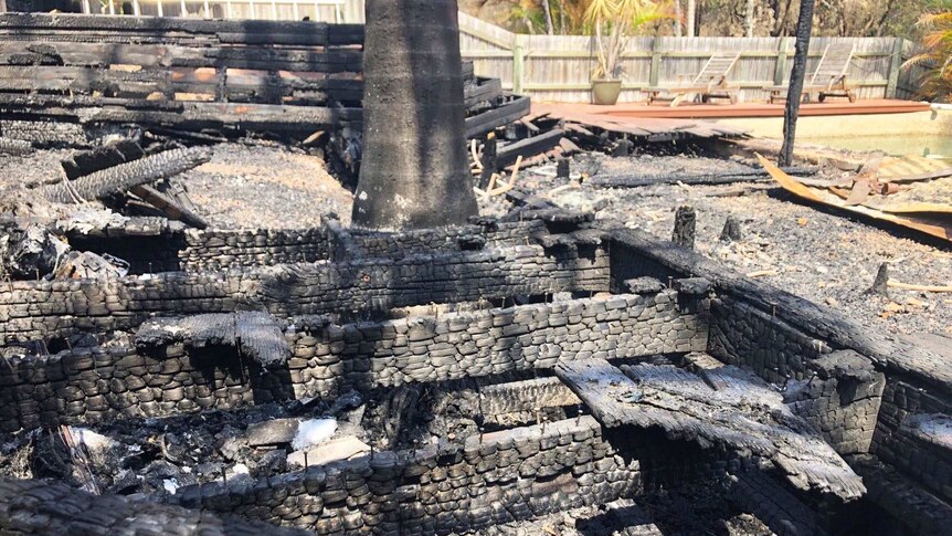 Charred remains of the back deck at the bushfire-destroyed home of Holly and David Kemp.
